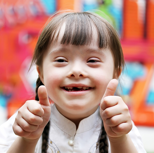 Close up of little girl giving double thumbs up