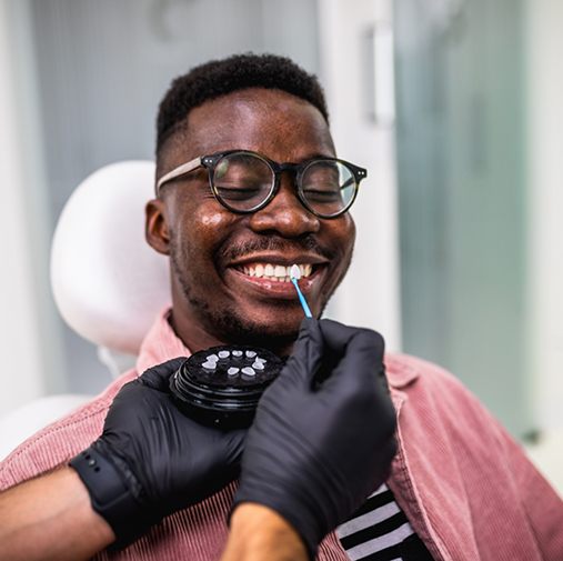 Male dental patient having teeth shade matched for veneers