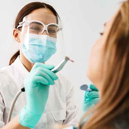 Dentist with mask about to treat patient