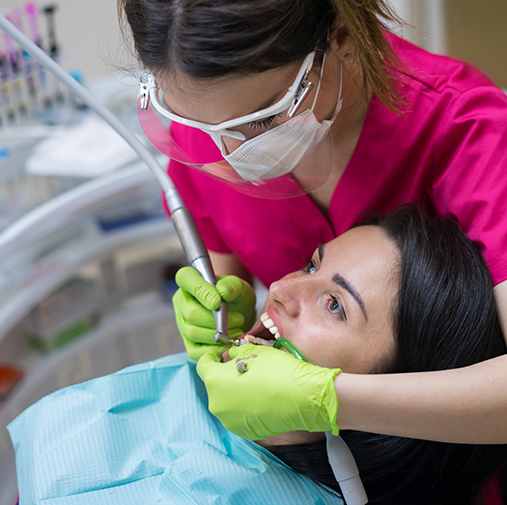 Dental patient having teeth cleaned by dentist