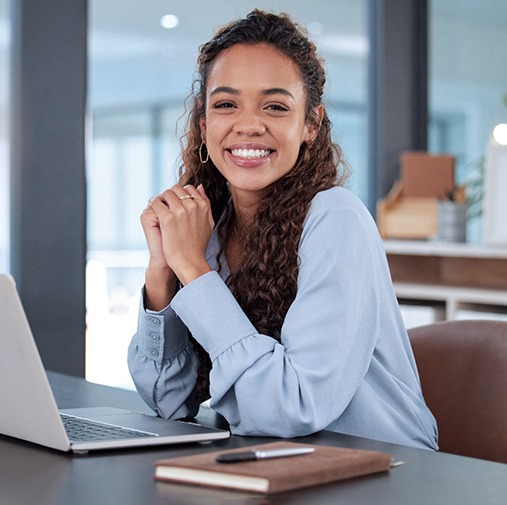 Woman smiling while working in office