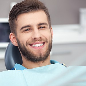 Man smiling while sitting in treatment chair