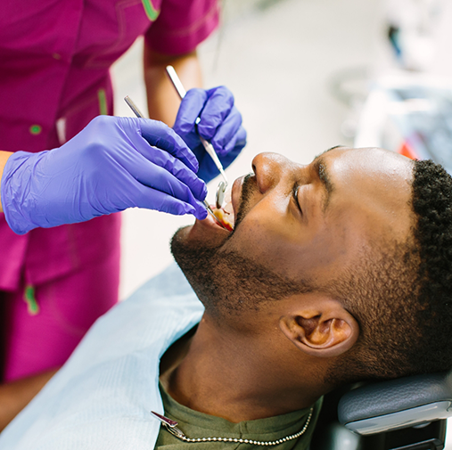 Man having teeth examined as example of preventive dentistry in Bellaire